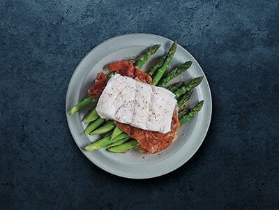 Skrei norvegese con asparagi e prosciutto crudo