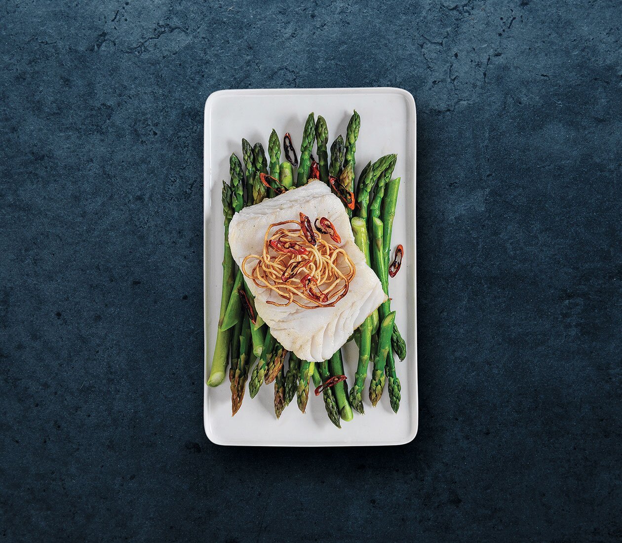 Skrei norvegese su letto di asparagi